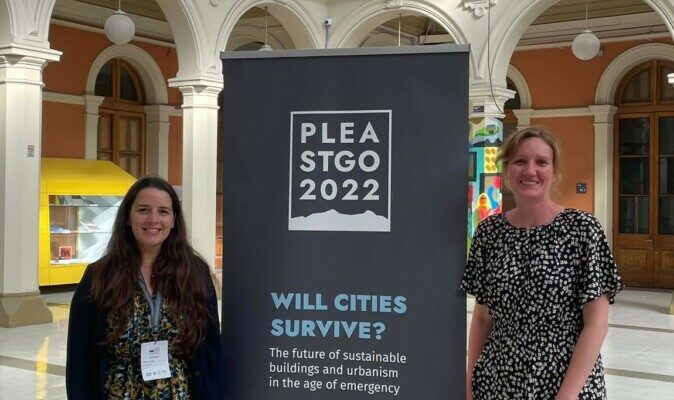 Two women stand in front of a poster that says PLEA 2022.